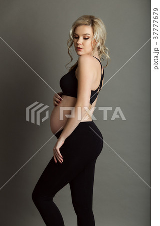 Pregnant beautiful blonde woman is wearing Pregnant beautiful blonde woman is wearing 37777679
