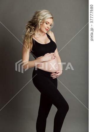Pregnant beautiful woman is wearing sportive black Pregnant beautiful woman is wearing sportive black 37777680