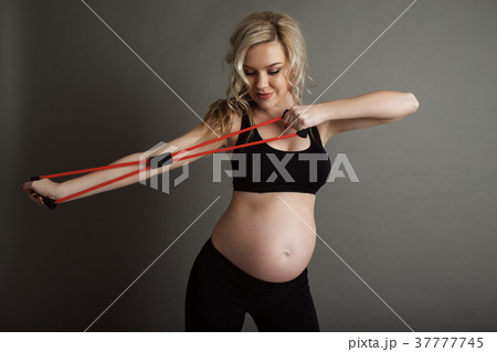 Pregnant beautiful blonde woman is wearing Pregnant beautiful blonde woman is wearing 37777745