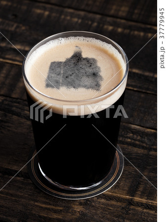 Glass of stout beer top with like symbol shape Glass of stout beer top with like symbol shape 37779945