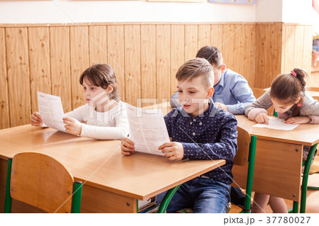Children taking an exam 37780027