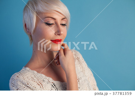 Portrait of blonde with short hair on a blue 37781359