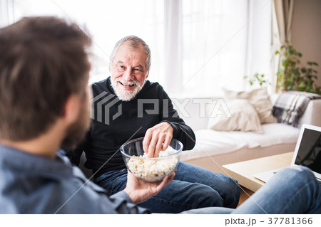 Hipster son and his senior father with laptop at 37781366