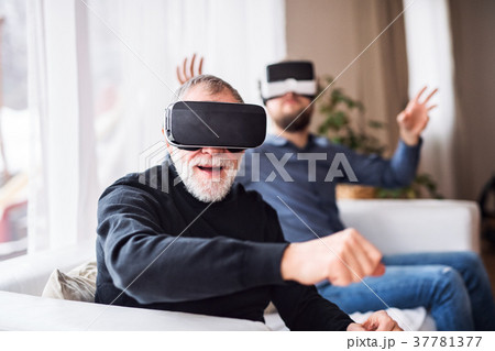 Hipster son and his senior father with VR goggles 37781377