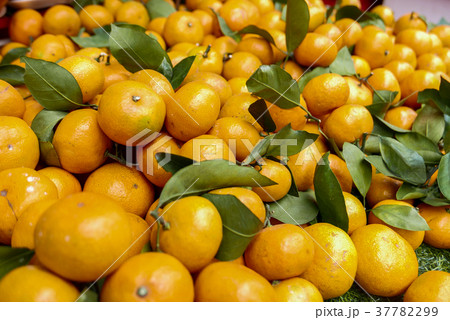 oranges, with leaves placed for sale at market. oranges, with leaves placed for sale at market. 37782299