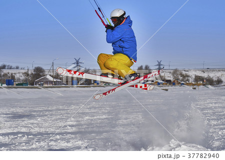 A male athlete engaged in snow kiting 37782940
