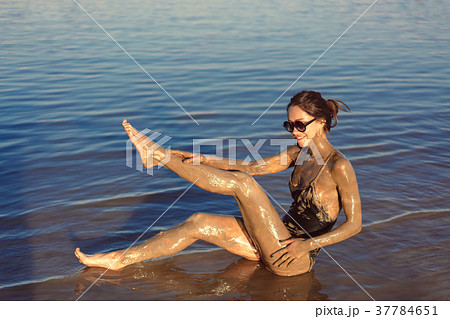 A young woman enjoying the natural mineral mud 37784651