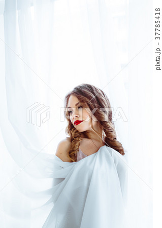 the woman standing at the window 37785418