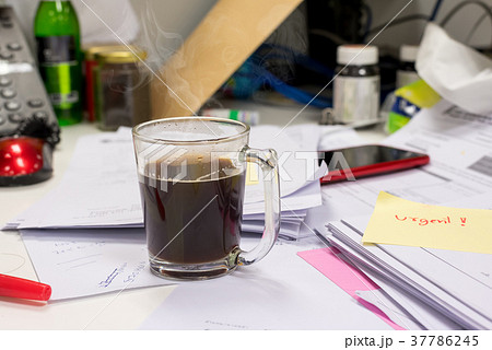Black coffee cup placed on a desk with work, 37786245