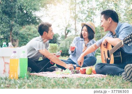 Young teen groups picnic in park together. Young teen groups picnic in park together. 37786303