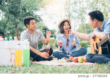 Young teen groups picnic in park together. Young teen groups picnic in park together. 37786304