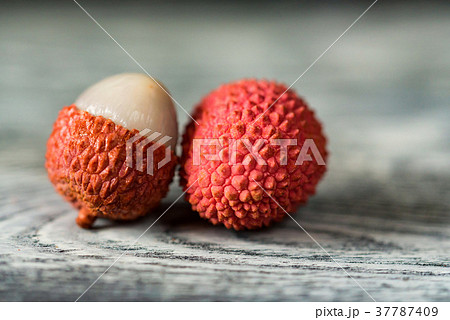 Two lychee fruits wooden background 37787409