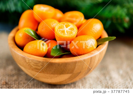 Kumquat or cumquat on wooden table Kumquat or cumquat on wooden table 37787745