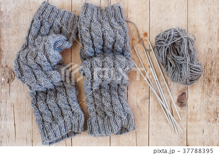 wool grey legwarmers, knitting needles and yarn 37788395