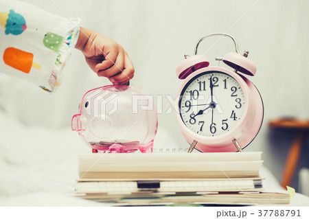 Little asian girl insert coin into piggy bank Little asian girl insert coin into piggy bank 37788791