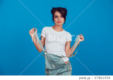 Attractive woman in a white t-shirt stands on a 37801459