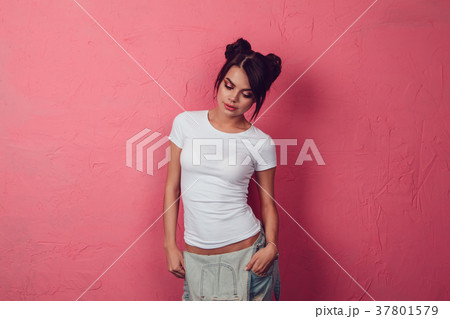 Attractive woman in a white t-shirt stands on a 37801579