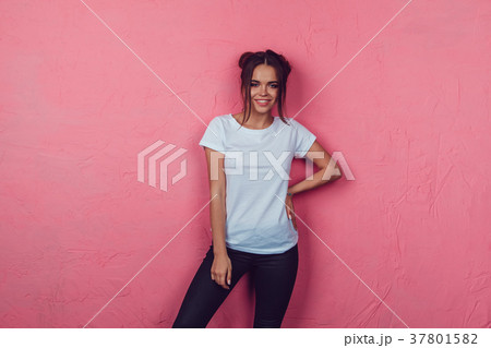 Attractive woman in a white t-shirt stands on a 37801582
