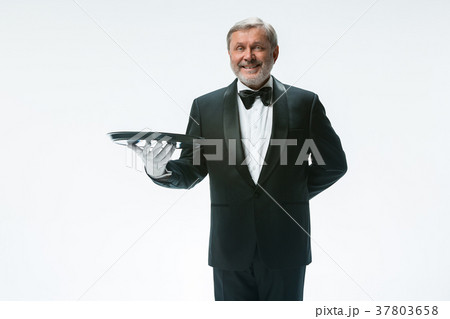 Senior waiter holding tray 37803658
