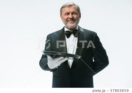 Senior waiter holding tray 37803659
