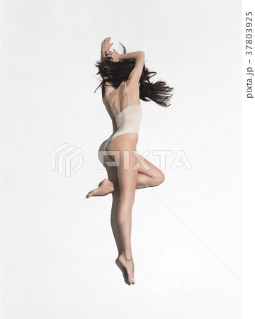 Young beautiful dancer in beige dress dancing on Young beautiful dancer in beige dress dancing on 37803925