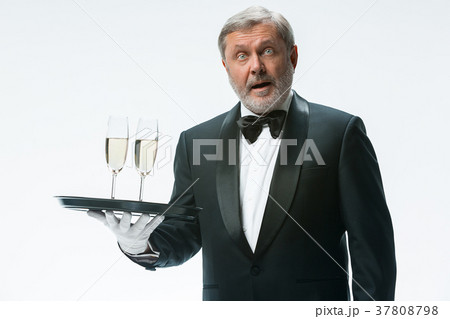 professional waiter in uniform is serving wine 37808798