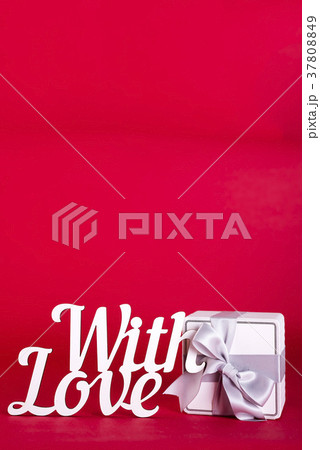 Gift box with silver ribbon bow 37808849