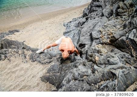 Man washing face with rain water 37809620