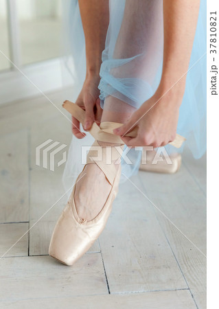 Ballerina puts pointe shoes 37810821