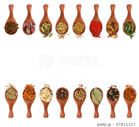 Different seasonings and spices in wooden spoons Different seasonings and spices in wooden spoons 37811127