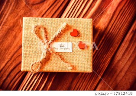 Valentine's giftbox andred hearts on wood Valentine's giftbox andred hearts on wood 37812419