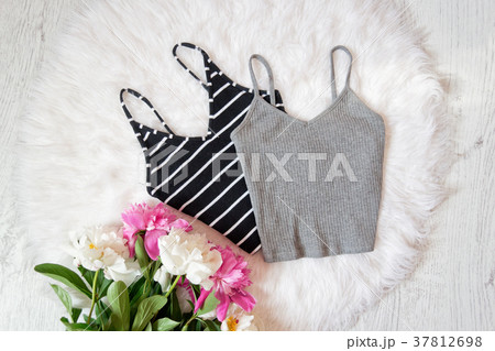 Black and gray tops, peonies on white fur Black and gray tops, peonies on white fur 37812698