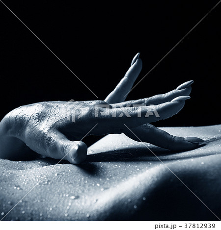 Close-up view of woman's hand touching her belly. Close-up view of woman's hand touching her belly. 37812939