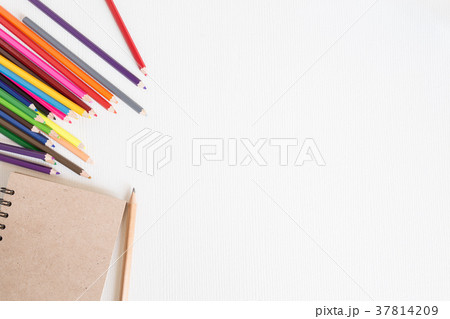 White wood desk with a notebook and crayon White wood desk with a notebook and crayon 37814209