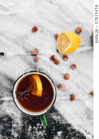 tea with lemon and cardamom on a snowy tea with lemon and cardamom on a snowy 37815458