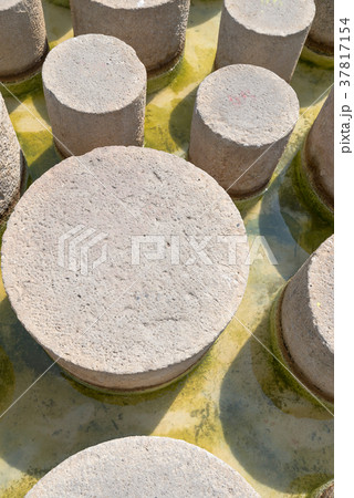 round concrete pillars on the beach in the water round concrete pillars on the beach in the water 37817154