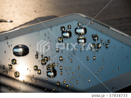 Drops of water spilled onto the tablet screen Drops of water spilled onto the tablet screen 37838735