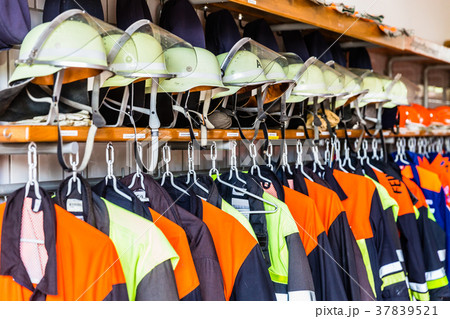 Helmets and uniforms in arsenal of fire fighters Helmets and uniforms in arsenal of fire fighters 37839521