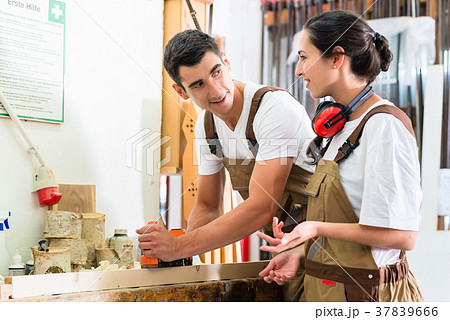 Carpenter team of woman and man working together Carpenter team of woman and man working together 37839666