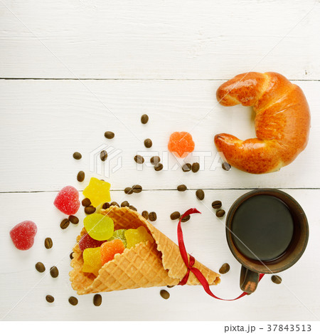 Cup of coffee, croissant, waffles and marmalade  Cup of coffee, croissant, waffles and marmalade  37843513