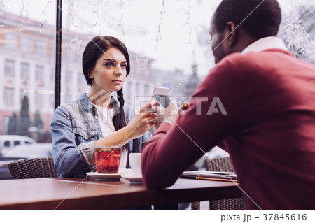 Charming thoughtful couple using phones Charming thoughtful couple using phones 37845616