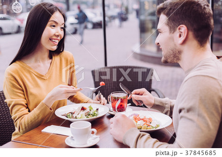 Charming pleasant couple eating dinner 37845685