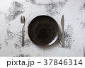 Black Plate on white wooden background  37846314