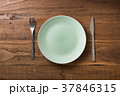 Green Plate on brown wooden background  37846315