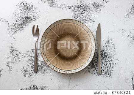 Plate on white wooden background with utensils Plate on white wooden background with utensils 37846321