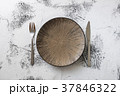 Plate on white wooden background with utensils 37846322