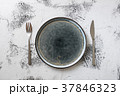 Plate on white wooden background with utensils 37846323