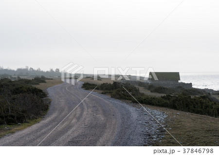 Winding gravel road by the coast 37846798