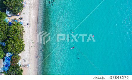 Aerial view of sandy beach with tourists swimming. Aerial view of sandy beach with tourists swimming. 37848576