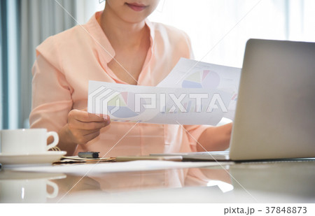 Businesswoman holding graphs and business chart 37848873